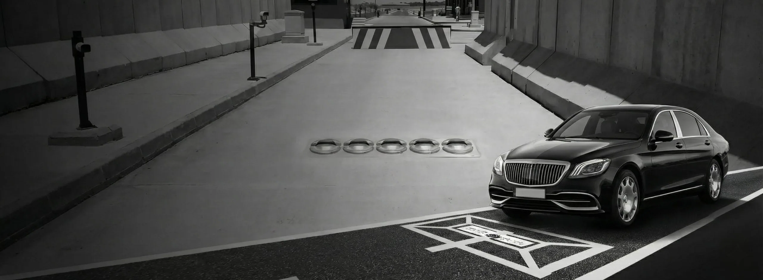 Vehicle passing over a flush-mounted under-vehicle scanner array at a secure checkpoint